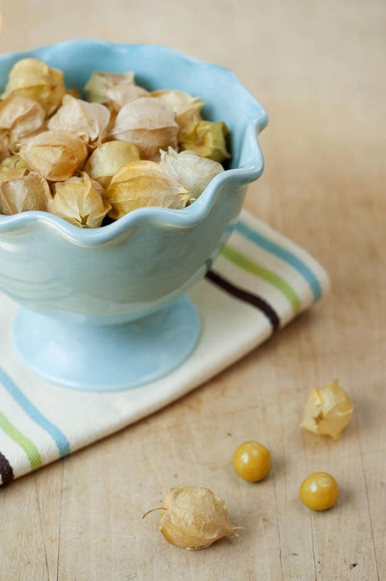 无人,竖图,俯视,室内,特写,白天,桌面,桌子,水果,阴影,花纹,新鲜,反射,木制,布,图案,影子,陶瓷,生食,食品,果实,陶瓷制品,布纹,食物,一个,木制品,容器,碗,摄影,有机食品,绿色食品,影棚,单个,储藏,布匹,储存,金灯,挂金灯,红姑娘,锦灯笼,酸浆,泡泡草,彩图,高角度拍摄,影棚拍摄,拍摄,贮存