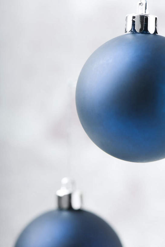 无人,竖图,室内,特写,白天,正面,桌面,桌子,静物,圣诞节,红色背景,节日,庆祝,装饰,垂吊,圆形,挂饰,圣诞球,文化,彩球,球,两个,蓝色,庆典,球体,磨砂,摄影,影棚,纪念,华丽,修饰,点缀,悬空,衬托,美观,雅致,雅观,彩图,影棚拍摄,拍摄