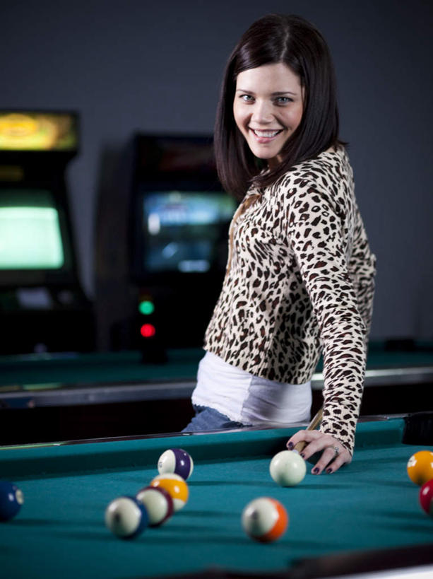 西方人,一个人,站,笑,微笑,露齿笑,竖图,室内,白天,侧面,台球,欧洲,欧洲人,仅一个年轻女性,仅一个女性,仅一个人,撑,撞球,阴影,服装,光线,球杆,影子,墙,灯光,注视,休闲装,运动器械,墙壁,墙面,彩球,衣服,观察,看,站着,休闲,休闲服,健身器械,豹纹,服饰,观看,察看,台球桌,撑着,关注,健身器材,斯诺克,桌球室,斯诺克球,斯诺克台球,桌球,年轻女性,女人,女性,白种人,长发,站立,半身,彩图,运动器材