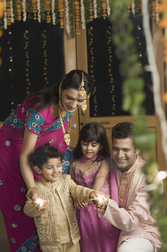 儿童,四个人,家庭,夫妻,母亲,父亲,女儿,儿子,站,蹲,笑,微笑,露齿笑,竖图,室外,白天,正面,民族服装,爱情,纯洁,门,项链,亚洲,朦胧,模糊,浪漫,拿,拿着,注视,装饰品,小孩,耳环,饰品,手链,首饰,门框,观察,看,站着,温暖,温馨,父女,父子,母女,母子,一家人,恩爱,父爱,可爱,母爱,童年,童趣,恋人,服饰,手镯,观看,飘逸,烟火棒,戴着,和睦,察看,庄重,关注,追求,镯子,童真,烂漫,无邪,纱丽,雅致,纱丽服,清婉,妍丽,天真,男孩,男人,男性,年轻男性,年轻女性,女孩,女人,女性,亚洲人,印度人,孩子,年轻人,夫妇,情侣,蹲着,站立,半身,彩图,传统服装,民俗服,伴侣,融洽,男生,女生,奢华