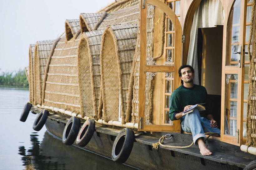 成年人,一个人,坐,横图,室外,白天,旅游,度假,湖,河流,印度,亚洲,仅一个男性,仅一个人,行人,游客,游人,路人,旅客,仅一个年轻男性,思考,放松,读书,运输,摄影,生活方式,航海,享乐,南亚,喀拉拉邦,印度共和国,过客,喀拉拉,男人,男性,年轻男性,印度人,年轻人,书,休闲活动,彩图,白日梦,船屋